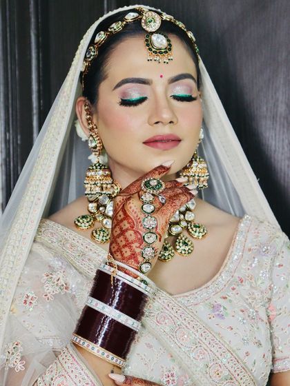 A serene portrait, with the focus on the bride's glowing skin and intricate jewellery.
