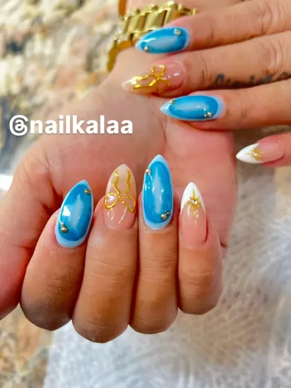 A bold and beautiful design with a vibrant blue "cat eye" effect, accented with gold 3D butterfly charms and pearls.