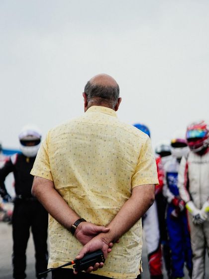 An official watches over the drivers on the grid.