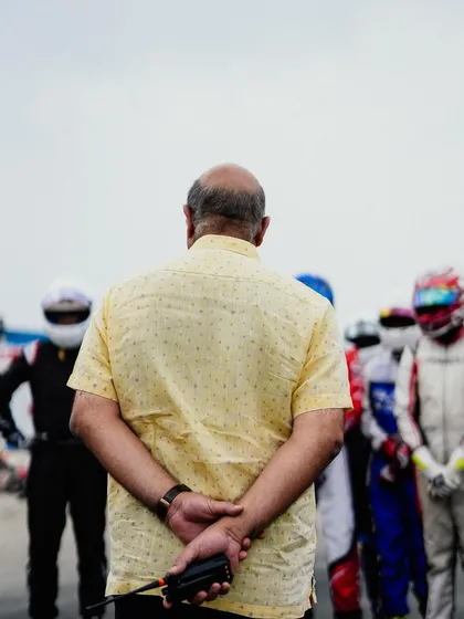 An official watches over the drivers on the grid.