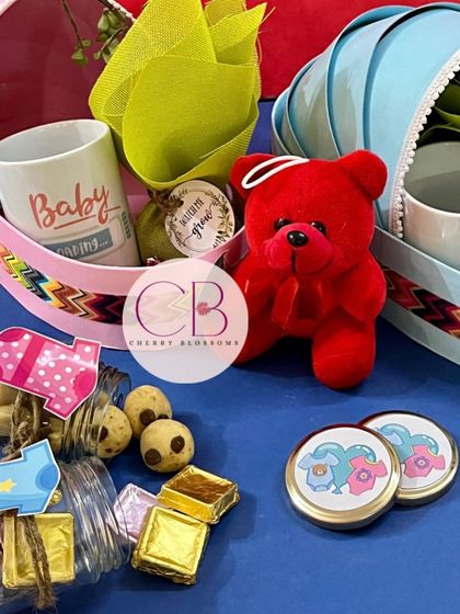 Another view of our popular baby shower hampers in cradle baskets. We can customise them in pink, blue, or any colour you choose, and fill them with gifts for the baby and mom.