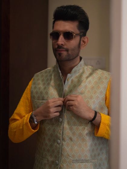 Buttoning up the jacket, a final touch to the outfit. Meticulous preparation is key to a flawless performance.