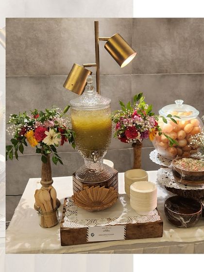 A classic golgappe station, elegantly presented with a glass dispenser for the spicy water and all the fillings arranged in neat bowls.