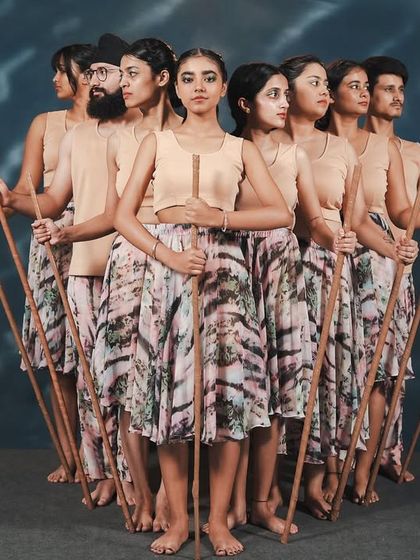 The cast of 'Synchronicity' in a powerful group formation with props. Our stage productions often incorporate unique elements to enhance the storytelling.