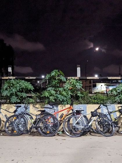 Our bikes lined up by the railway tracks under a cloudy night sky, with the moon peeking through. This stack captures the adventurous spirit of our Horamavu ride.