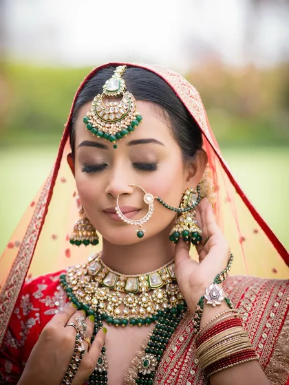 A close-up on the details. The perfectly blended eyeshadow and the intricate nath are a testament to the artistry involved in creating a timeless bridal look.