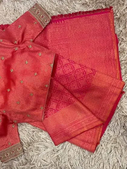 The front view of the pink embroidered blouse and matching saree, a perfect ensemble for a daytime event.