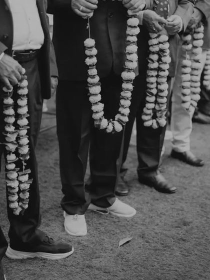 The groom's side waiting to welcome the bride's family. This black and white shot captures the anticipation and tradition of the Baraat Swaagat ceremony.