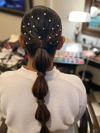 The final look of the pearly bubble ponytail, a perfect hairstyle for a Sangeet or cocktail event.