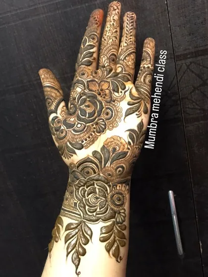 This full-hand design is a masterpiece of shading and detail, with a beautiful rose cuff at the wrist.