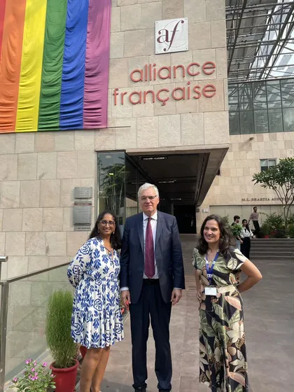 Our team with Dominique Antoine in front of our building, adorned with the Pride flag. We are proud to be a welcoming and inclusive center for all.