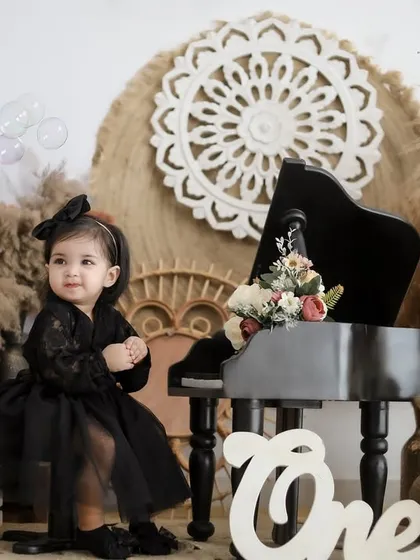 Capturing a moment of wonder as bubbles float by during a first birthday photoshoot. The soft lighting and boho elements add a touch of magic to the scene.