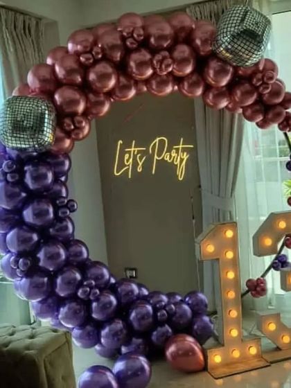 A fun and trendy "Let's Party" theme for a 13th birthday. The two-tone balloon ring, disco ball accents, and marquee numbers create a perfect disco vibe.