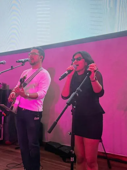 Sharing the stage and a microphone with my guru. This photo shows our close collaboration and the dynamic energy we have when performing together.