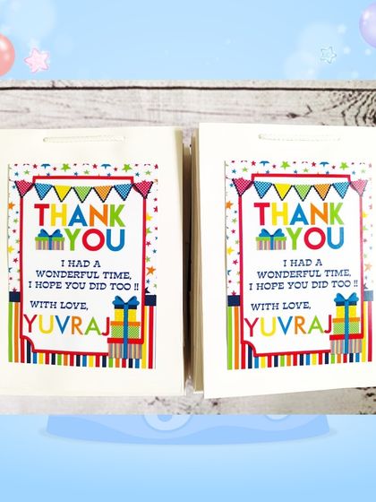 The custom paper bags for the stationery set gifts, featuring a colorful design and a thank you message from Yuvraj.