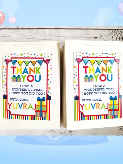 The custom paper bags for the stationery set gifts, featuring a colorful design and a thank you message from Yuvraj.