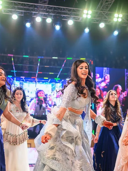 A candid shot of the bride and her bridesmaids enjoying their performance. It's all about having fun together on stage.