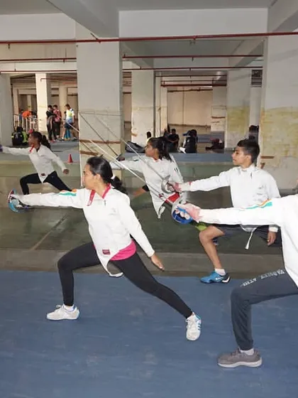 Our fencers practice their en garde stance and blade presentation in unison. Group drills like these instill discipline and ensure every athlete masters the fundamentals of fencing.