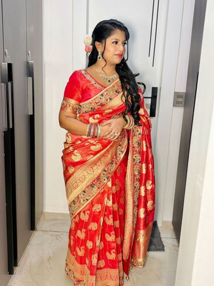 A full-length shot of the client, her saree draped perfectly.