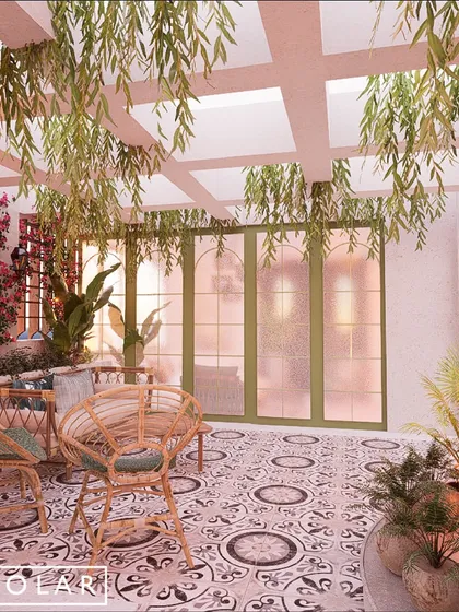 Lush greenery, including hanging plants and flowering vines, transforms the terrace into a private garden. Soft, ambient lighting enhances the tranquil vibe in the evening.