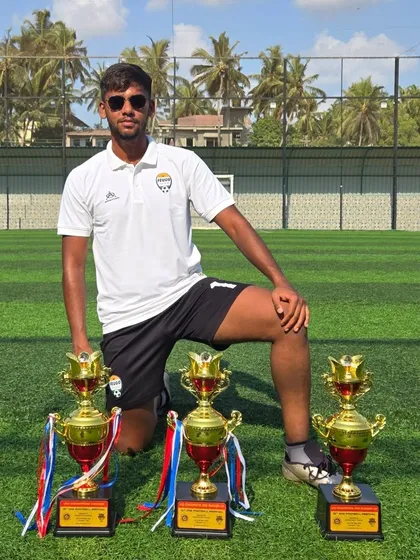 Coach Mohit Singh with the trophies, a reflection of his dedication and the team's hard work.