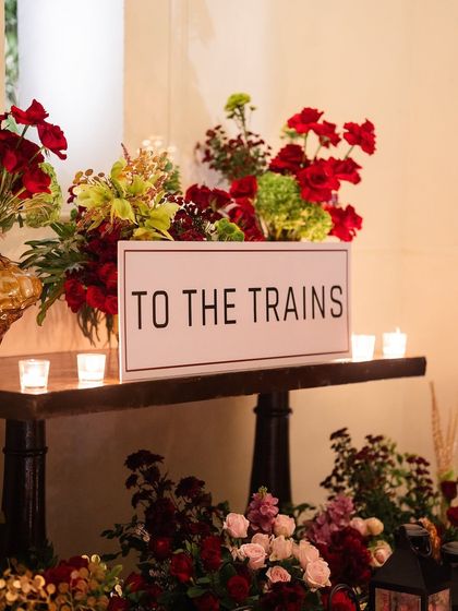 A simple sign directs guests "To The Trains," building anticipation and setting the stage for the immersive experience ahead.