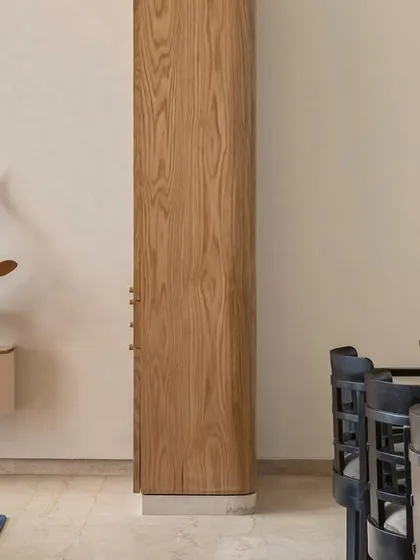 A glimpse into the open-plan living and dining area of Apartment 3201. We used natural oak and black stained wood to create a blended, cosmopolitan space that reflects the clients' Indian and Dutch heritage, perfect for fostering togetherness.