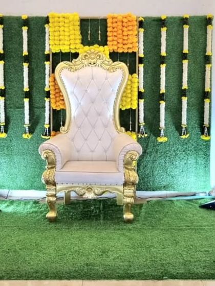 The same traditional backdrop, now complete with an ornate white and gold throne for a naming ceremony or baby shower.