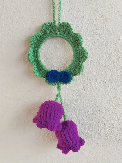 A green and purple car hanging with bell-shaped flowers.