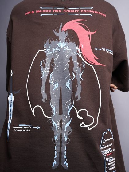 A detailed view of the impressive anime-style graphic on the back of a brown t-shirt. This image is designed to appeal to fans of graphic art and streetwear culture.