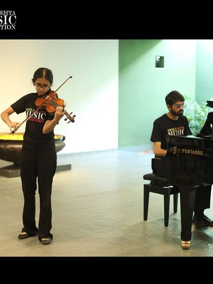 A violin and piano duo perform amidst beautiful works of art. The synergy between visual art and music created a truly memorable experience for the audience.
