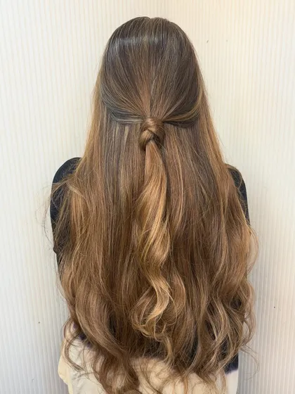 Blonde and curly is a statement. This look is all about volume, texture, and a beautiful blonde balayage that shines.