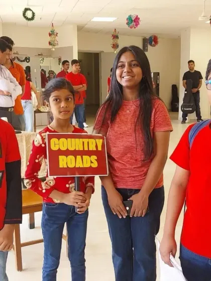 Students get ready for their performance of "Country Roads". This behind the scenes moment captures the excitement and camaraderie before the show begins.