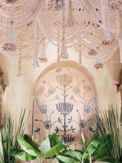 A closer view of the heritage-inspired stage, showing the rich textures of the hanging florals and the ornate details of the golden jharokhas.