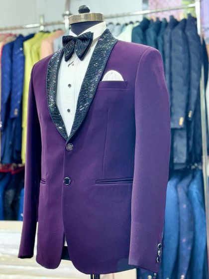 A side view of the purple tuxedo with a sparkling black lapel, seen in my store. This shows the outfit in a retail context, surrounded by other colorful options.
