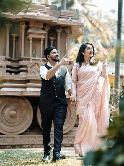 A couple in traditional attire explores a set designed like an ancient temple chariot, adding a touch of history and grandeur to their pre-wedding shoot.