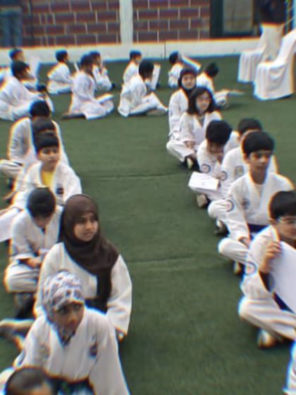 Discipline starts with listening. Students sit attentively during an outdoor session, ready to absorb the lessons of the day.