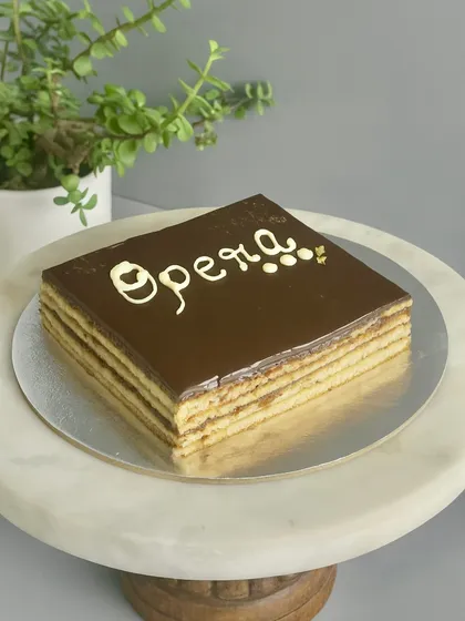 I have a deep love for the classics, and my Opera Cake is a perfect example. It's a harmony of coffee, chocolate, and almond sponge, with each layer crafted to be rich, elegant, and timeless. A true showstopper for any celebration.