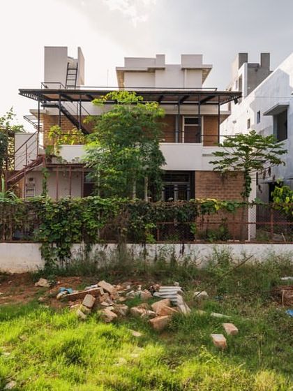 A view of the Samvrruddhi residence a year after completion, now enveloped in lush greenery. Our designs encourage this integration with nature, allowing the home to evolve and grow with its landscape.