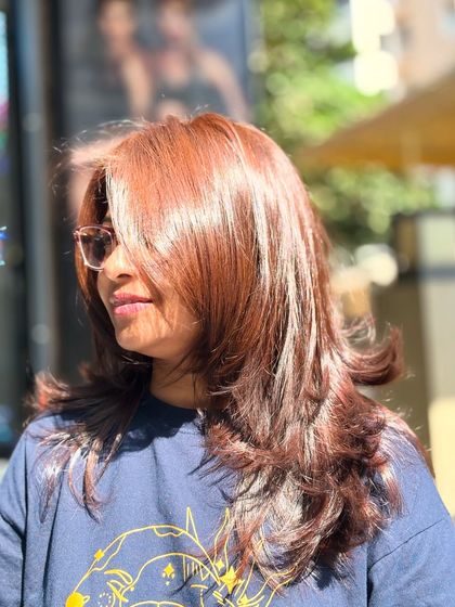 A side view of the mocha brown hair, showing how the layers and color create a soft, face-framing effect.