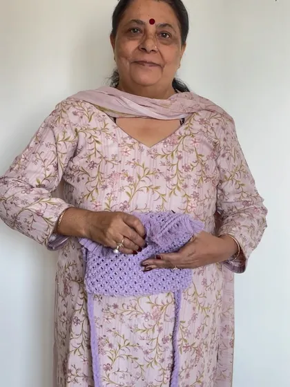 Here I am with a lovely lavender macrame sling bag. We charge a little extra for linings because we custom source the fabric to match your chosen color and hand stitch it.