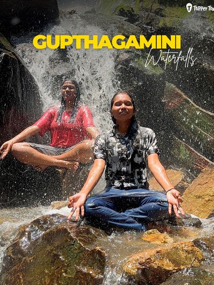 Two women meditate under the Gupthagamini waterfalls in offbeat Chikmagalur. My trips take you to hidden gems where you can connect with nature on a deeper level.