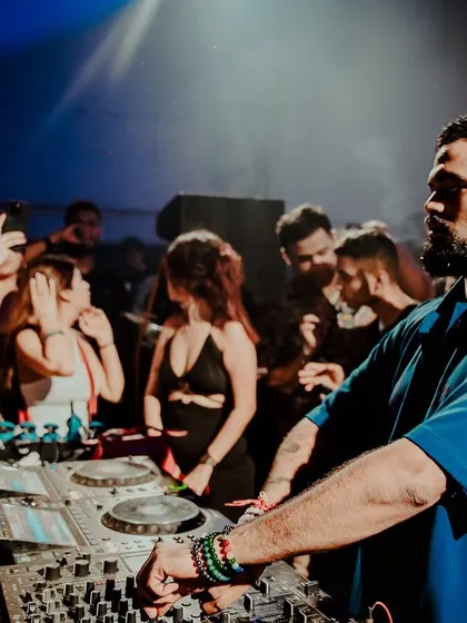 A shot of me looking out over the crowd in a packed club, reading the energy and planning my next move.