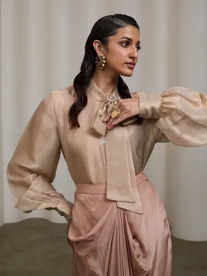 A polished lookbook image for an Indo-western brand. My goal here was to create a clean, commercial look that highlights the garment's texture and elegant silhouette. The soft studio lighting and minimal set allow the sophisticated design and the model's graceful pose to take center stage.