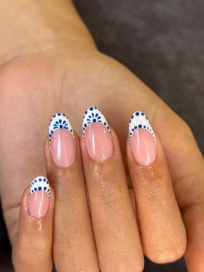 Blue-tiful nails, don't you think? This design features a delicate blue and white boho pattern on the tips for a unique take on the French manicure.