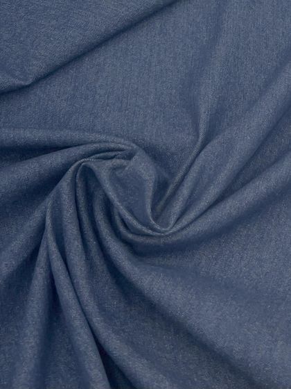 The rich texture and deep blue color of our soft denim fabric. It's a versatile material that can be used for everything from pants and jackets to modern kurtas.