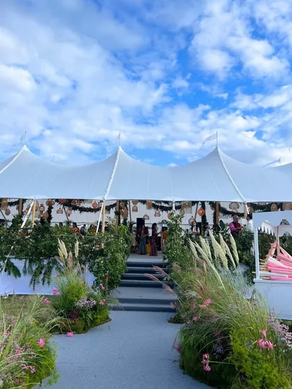 The entrance to a grand marquee tent set up in the English countryside for a Mehendi. We can build stunning venues from scratch in any location.