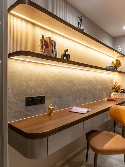 This custom study zone blends form with finesse. A warm walnut-toned worktop with rounded edges, subtle fluting, and soft grey stone textures set the tone for a space that inspires focus without compromising on style.
