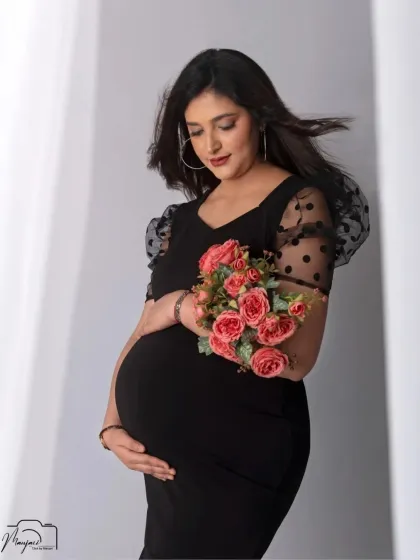 A beautiful and serene solo portrait. The flowers add a soft, romantic touch to the modern and chic black dress.