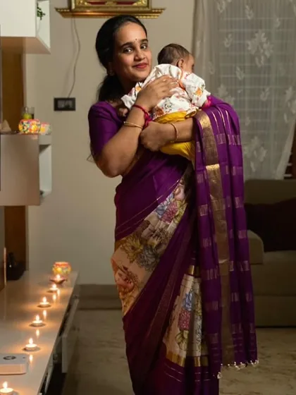 A happy client celebrating Diwali in her pure Mysore crepe digital print saree. The purple and white combination looks festive and beautiful.